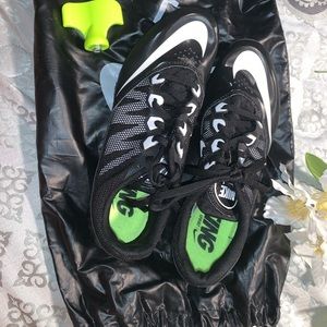 Black and white track spikes / shoes